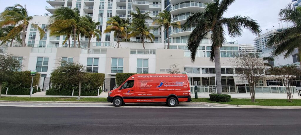 Red SourceOne Truck in front of Fort Lauderdale Condo Building