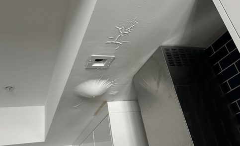 Bubbled ceiling from water damage.