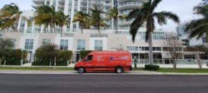 Red SourceOne Van in front of Condo.